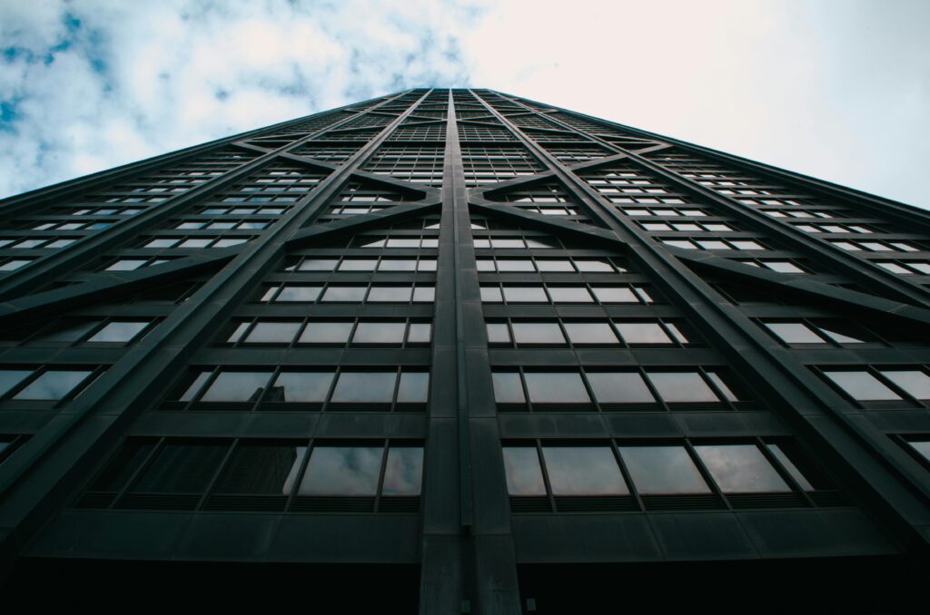 pexels-photo-678117-678117 An upward perspective of a modern glass skyscraper against a cloudy sky in downtown Chicago.